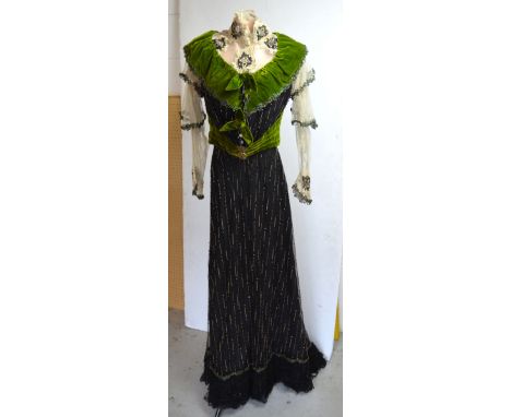 A 19th century black and chartreuse silk and velvet evening skirt and bodice, net overlay to both, heavily beaded with bugle 