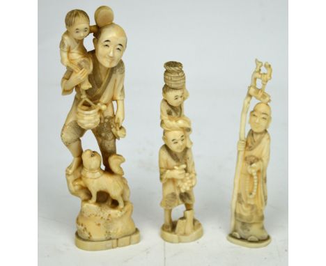 Three early 20th century Japanese ivory figures; a man carrying a child holding a basket on his shoulders, red signature mark