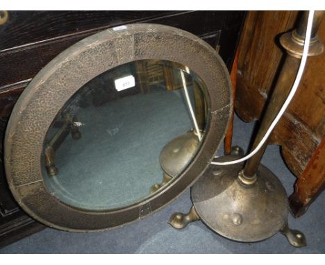 A 1920S CIRCULAR WALL MIRROR in an anodised brass frame and a similar standard lamp (2)