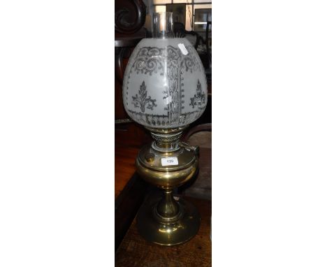 A VICTORIAN BRASS OIL LAMP with acid etched shade (cracked and glass chimney), overall, 22" high