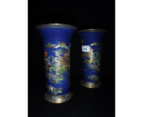 A PAIR OF CARLTONWARE PORCELAIN CYLINDRICAL VASES with chinoiserie, polychrome and gilt decoration on blue ground, 8" high