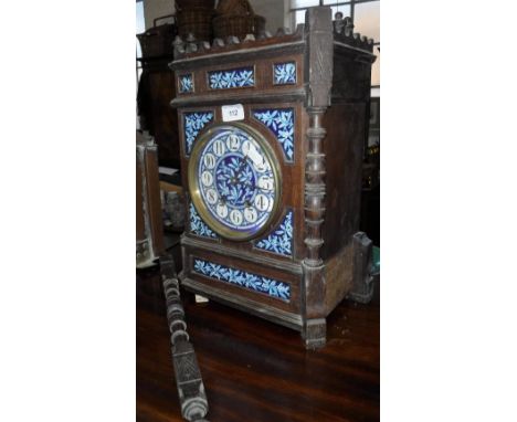 A LATE 19TH CENTURY AESTHETIC MOVEMENT BRACKET CLOCK, the oak case with ceramic panels decorated with blue and white holly wi
