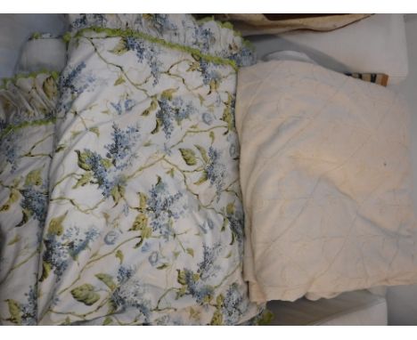 A PAIR OF CREAM AND EMBROIDERED LINEN CURTAINS and one other set of curtains with a floral pattern 