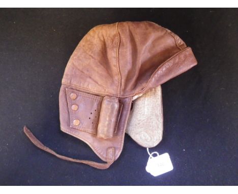A VINTAGE "GROSSE" BROWN LEATHER MOTOR CYCLE OR MOTORING HELMET