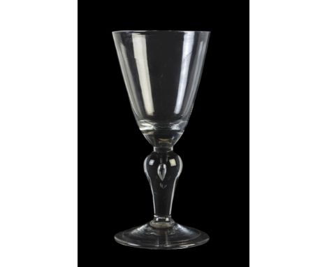 A baluster wine glass, second quarter 18th century, the round funnel bowl with solid lower section and supported on an invert