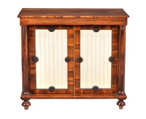 A George IV goncalo alves side cabinet, circa 1825, with pair of silk pleated doors enclosing a shelf, 92cm high, 100cm wide,