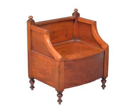A Regency mahogany night commode, circa 1820, the three quarter upstand above the hinged lid enclosing a further turned lid a