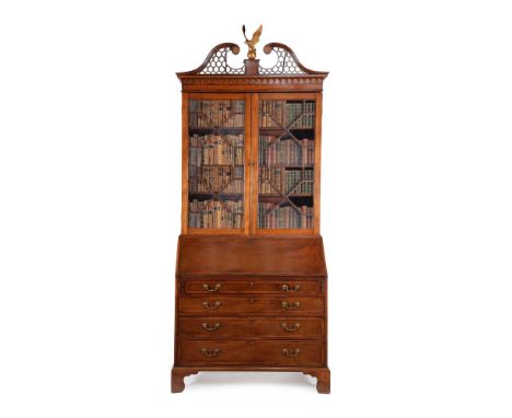 A George III mahogany and crossbanded bureau bookcase, circa 1780, the pierced fretwork pediment incorporating parquetry roun