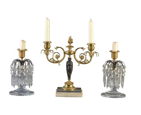 A pair of Regency cut glass and gilt and patinated bronze lustre candlesticks, circa 1815, each with an engine milled urn soc