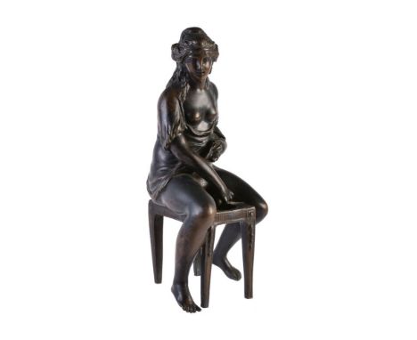 Manner of Clodion (French, 1738-1814), a French patinated bronze model of a lady at her toilette, probably 18th century, the 