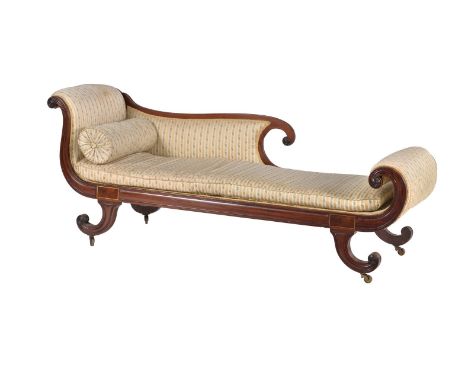 A Regency mahogany and brass inlaid chaise longue, circa 1815, the scrolled and padded back, head and footboard, above the fi