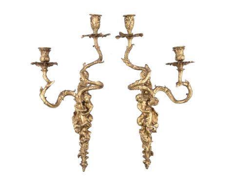 A set of four gilt bronze twin light figural wall appliques in Louis XV style, first quarter 20th century, each with two foli