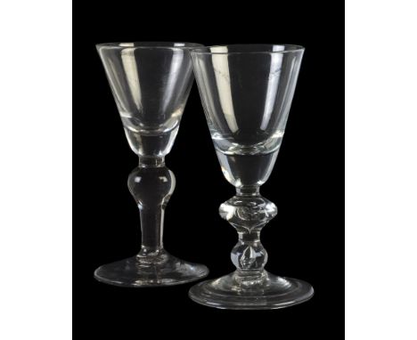 Two baluster wine glasses, various dates mid-18th century, each with the round funnel bowl with solid lower section, both wit