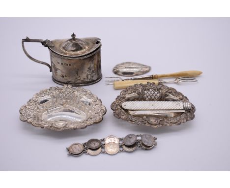A small group of silver items, to include:&nbsp;an Edwardian silver mustard; a Georgian caddy spoon; and a mother of pearl si
