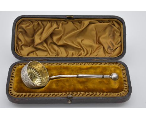 A cased Continental silver plated ornate straining ladle,&nbsp;having gilt bowl, 15cm long, 