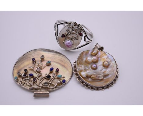 An impressive shell pendant, decorated amethyst, turquoise and rose quartz, stamped 925; together with a mother of pearl exam