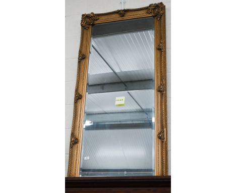 A large Baroque style gilt framed wall mirror with bevelled plate 