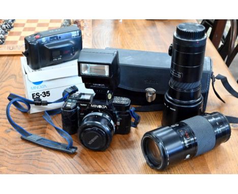 A Minolta 7000 SLR 35 mm camera, with AF zoom 35-70 mm 1:4 (22) lens, AF zoom 70-210 mm 1:4 (32) lens and Sigma AF Tele 400 m