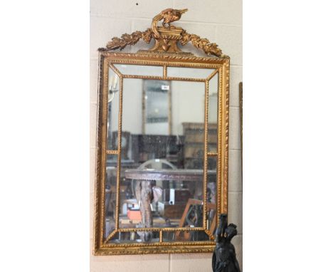 A large rectangular wall mirror in decorative gilt frame with foliate supported pedestal crest surmounted by ho-ho bird, 70 c