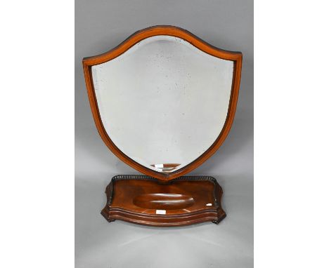 A large Victorian Sheraton Revival mahogany framed adjustable shield shaped toilet mirror, with bevel edged plate, raised on 