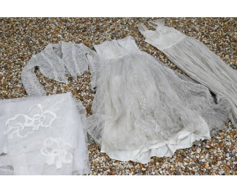 A vintage lace, gauze and silk wedding dress with petticoat, full pleated underskirt, buttoned jacket and veil 