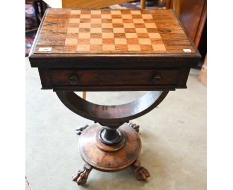 A Victorian rosewood and maple games table with folding chessboard top and single drawer, circular platform base with paw fee