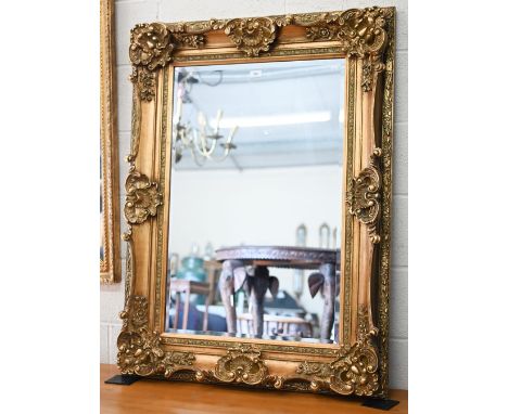 A 'Hookes' reproduction gilt framed mirror in the baroque style with bevelled rectangular plate, 120 cm x 90 cm 