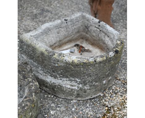 An antique cut stone demi-lune sink/trough 