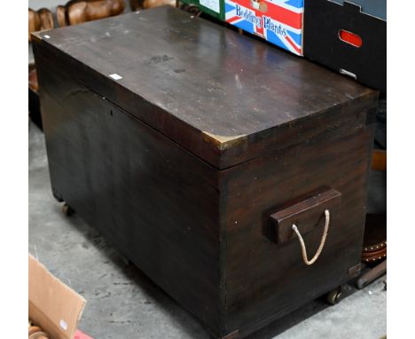 An antique brass bound teak trunk with rope carrying handles, on castors 102 x 54 x 70 cm high 