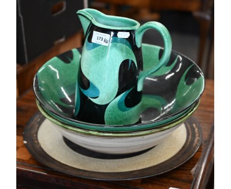 A Jane Cox studio pottery ewer and basin painted with stylised foliate design, signed on bases, bowl 36 cm diameter, to/w a 3