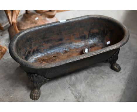 An old cast iron planter trough raised on paw feet, 70 x 36 x 26 cm high 