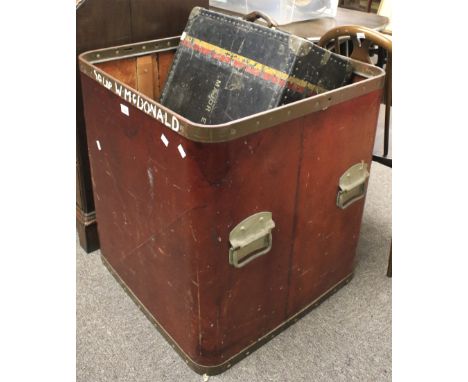 A large wooden storage box and a vintage trunk. The box of square form with a metal rim and stained red exterior, L65cm x D65