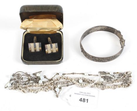 An assortment of silver and white metal jewellery. Comprising a pair of cufflinks, a bangle and two necklaces, combined weigh