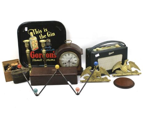 An assortment of collectables. Including a chess set, mantle clock, vintage radio and a pair of candlesticks