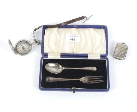 A military compass, vesta case and a silver fork and spoon set. The compass with a key and metal strap, the fork and spoon se