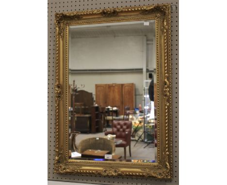 A 20th century gilt framed wall mirror. With bevelled edge, 65cm x 91cm