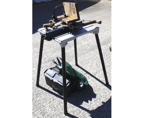 A small workbench and an assortment of tools. Including a wooden handled jigsaw, workbench H78cm 