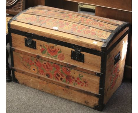 A vintage domed-top pine trunk. Painted with flowers and foliage, with metal locks and handles to either side, L80cm x D46cm 