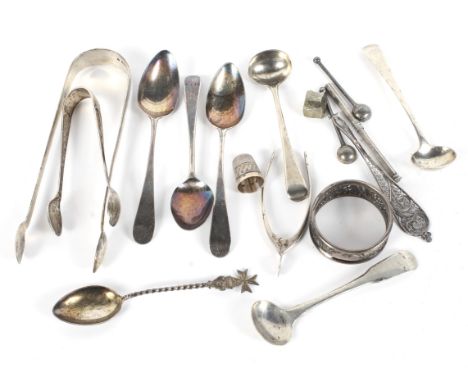 An assortment of silver and white metal. Including flatware, a thimble and a napkin ring