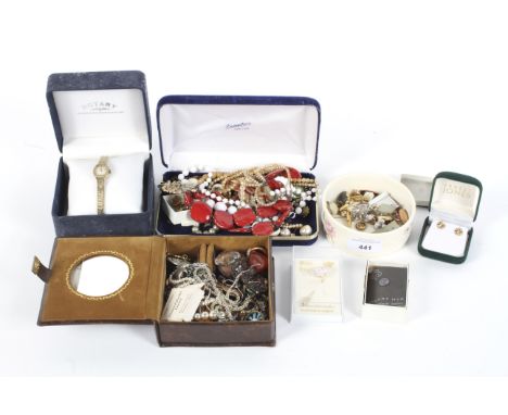 An assortment of vintage costume jewellery. Including a pair of 9ct gold earrings, Swarovski ring, enamel badges, strings of 