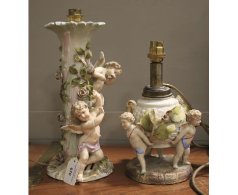 Two 20th century continental porcelain table lamps. Each depicting cherubs amongst vines and foliage, largest H28cm  Conditio