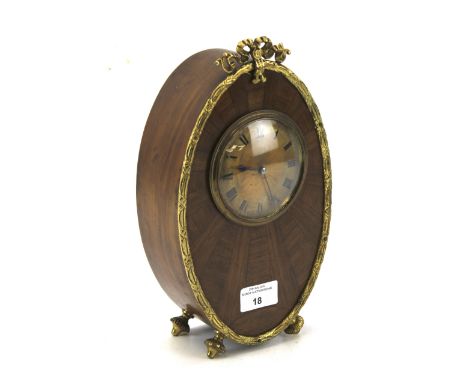 An early 20th century mahogany inlaid French mantel clock. The gilt engine turned dial with Roman numerals denoting hours, wi