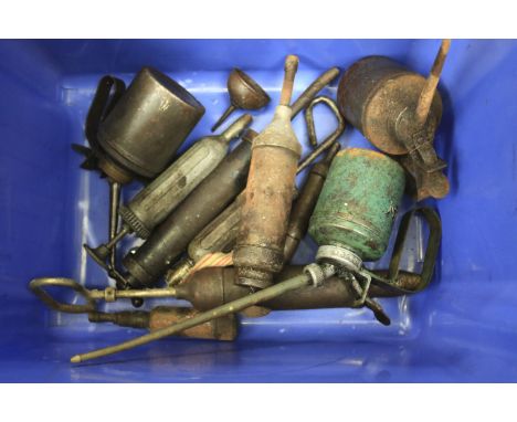 An assortment of motoring oil cans and tools. Some with printed details