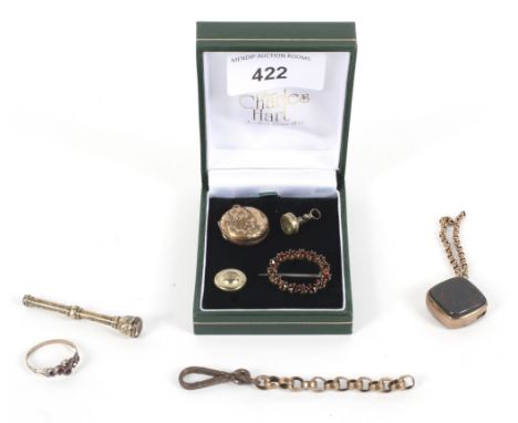 An assortment of yellow metal item. Including a propelling pencil, stone set fob, locket, brooch, etc