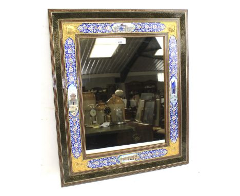 A highly decorated Indian wall mirror. With multiple borders decorated with monuments and gilt scutchings, L54.5cm x H65cm 