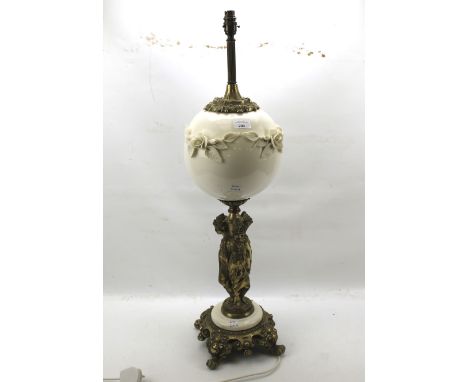 A 20th century gilt metal and porcelain table lamp. The upper section featuring a ceramic orb decorated with flowers, attache