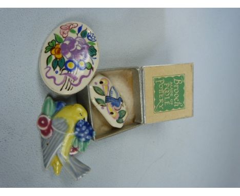 Three Poole Pottery brooches - 1 in original box