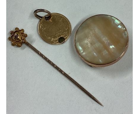 A small gold coin together with a stick pin etc. Approx. 6 grams of gross weight. Est. £20 - £30.