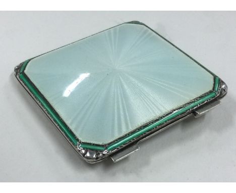 A silver and gold mounted, white and green enamelled compact. Birmingham 1940. By Adie Brothers. Approx. 77 grams. Est. £100 