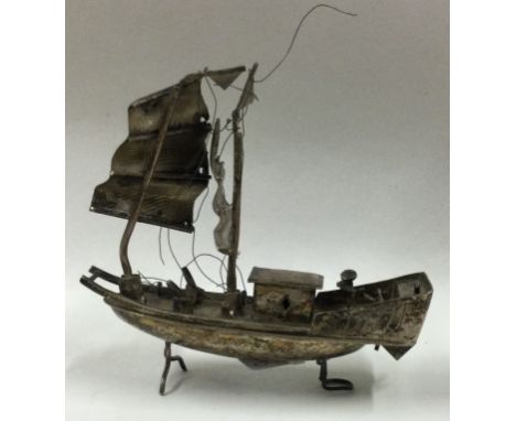 A 19th Century Chinese silver model of a junk. Approx. 25 grams. Est. £30 - £40.